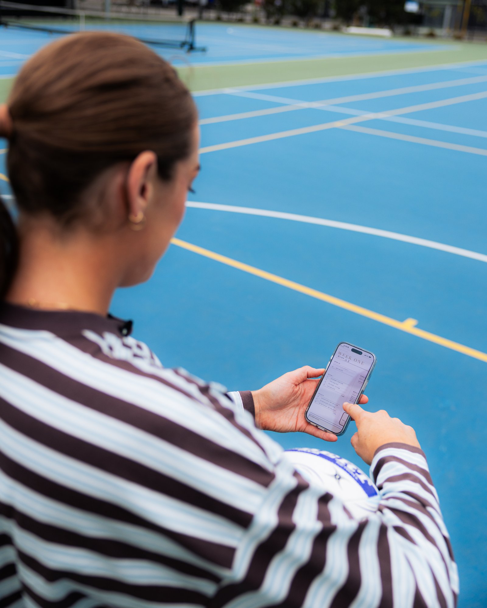 Sophie reviewing the program courtside